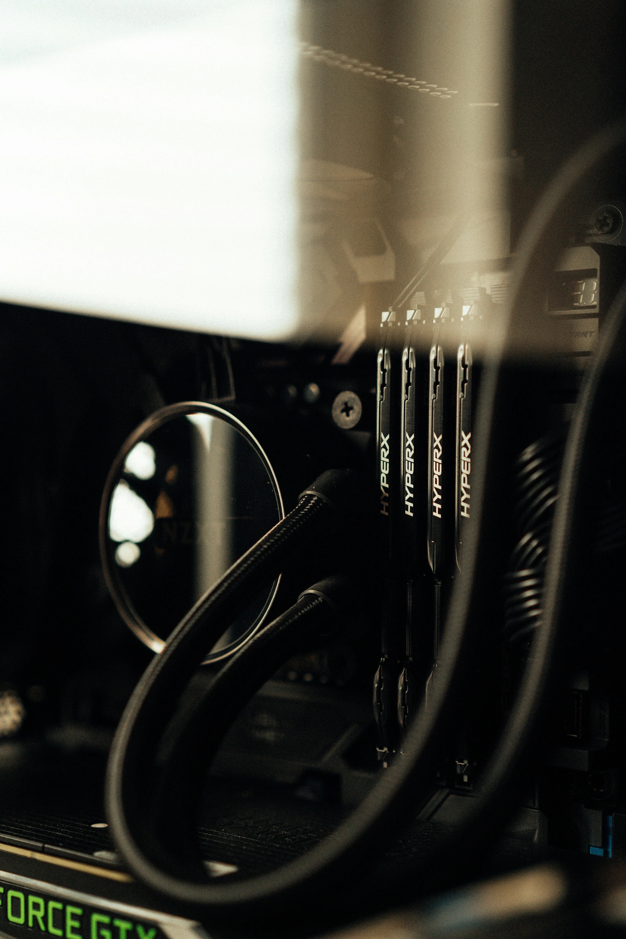 Close-up of computer hardware with memory modules and cooling tubes